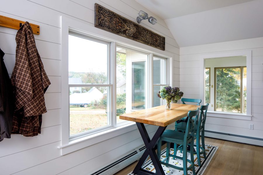 white interior room with foldable table and green wooden chair