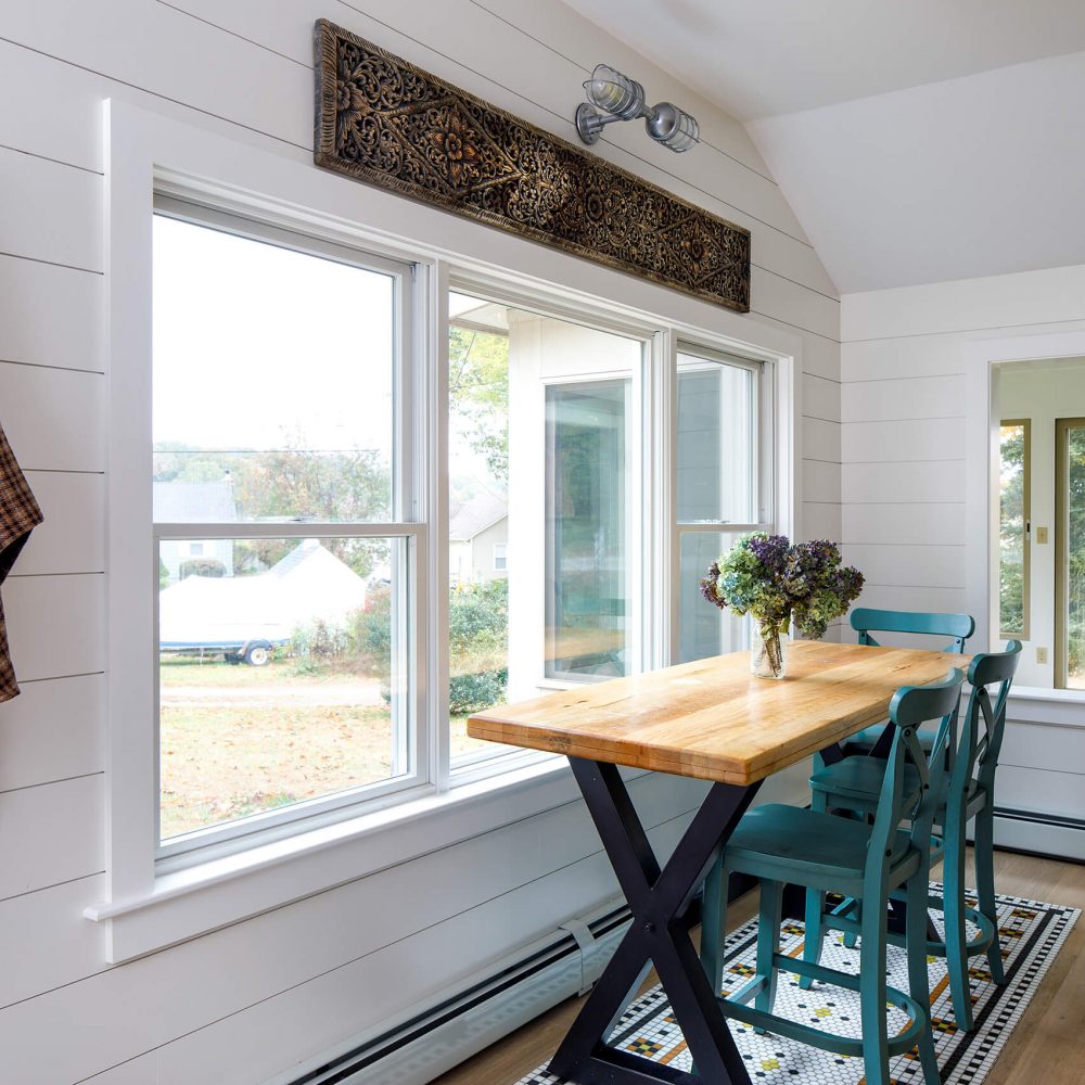 white interior room with foldable table and green wooden chair