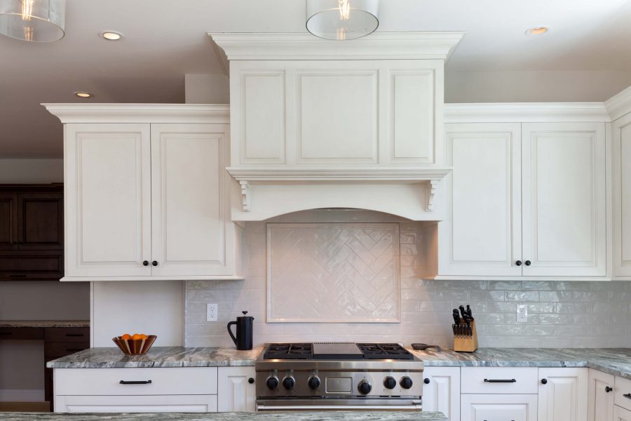 white kitchen interior with stainless stove