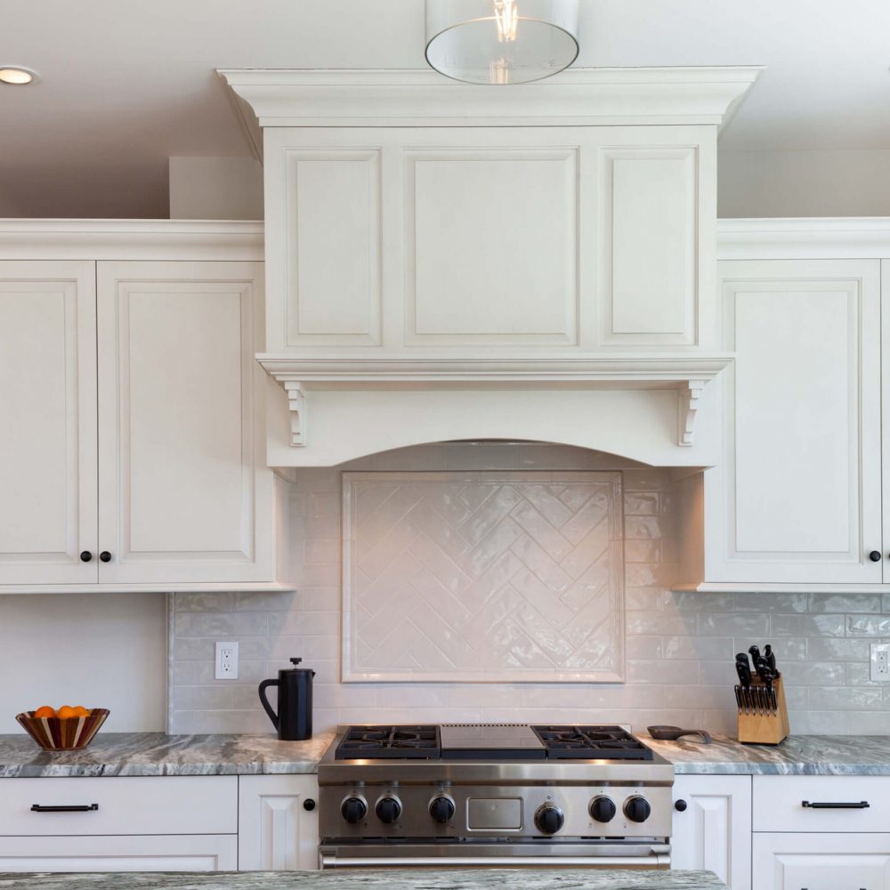 white kitchen interior with stainless stove