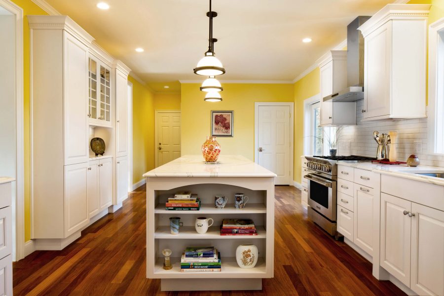 Yellow wall and white cabinets kitchen design