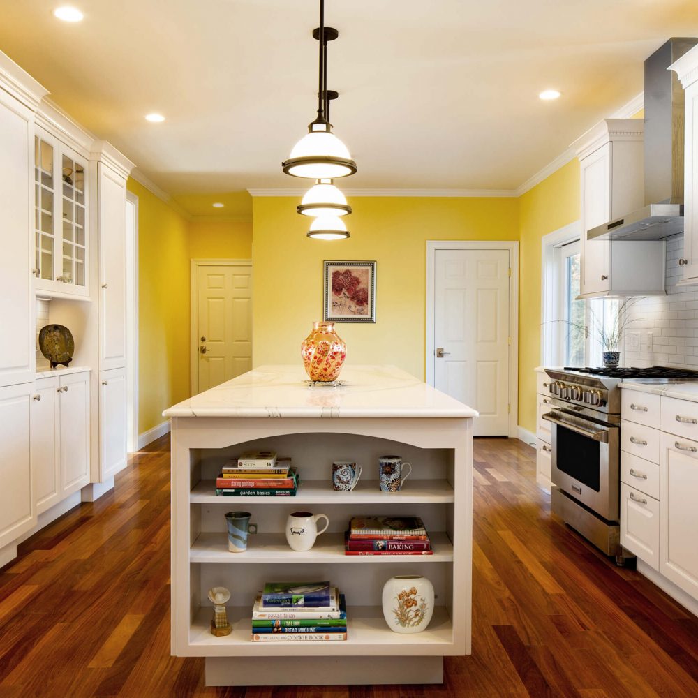 Yellow wall and white cabinets kitchen design